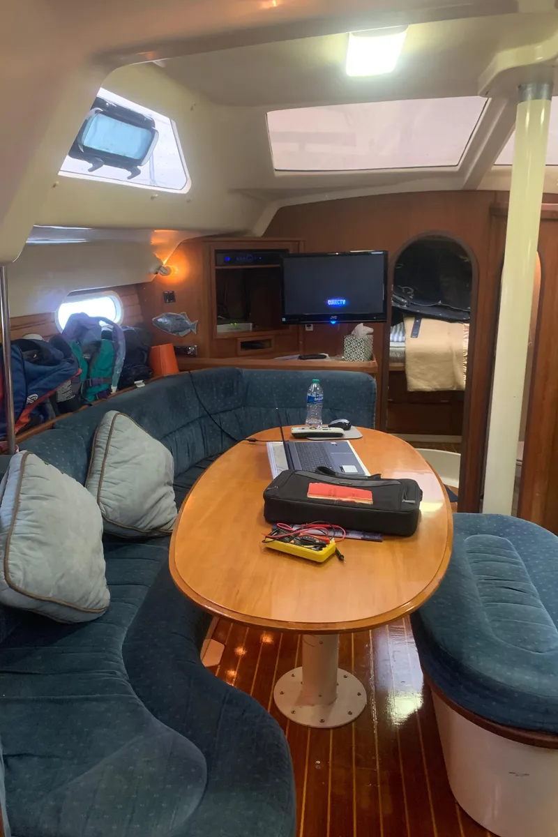 Slide: The Image of 1998 Hunter Passage 42 sailboat docked in a serene marina setting. - 6