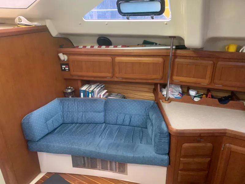 Slide: The Image of Interior of 1998 Hunter Passage 42 sailboat with cozy seating and wooden table. - 7