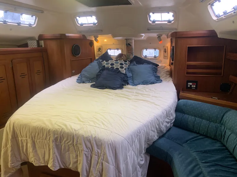 Slide: The Image of 1998 Hunter Passage 42 yacht kitchen with stove, coffee maker, and wooden cabinetry. - 9