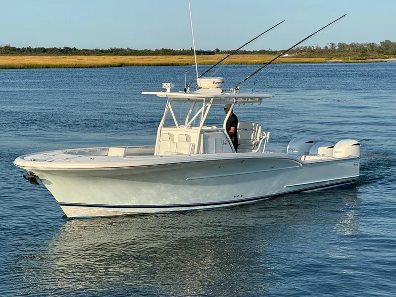 Slide: The Image of 2017 Buddy Davis 34 cc boat cruising on calm water. - 0