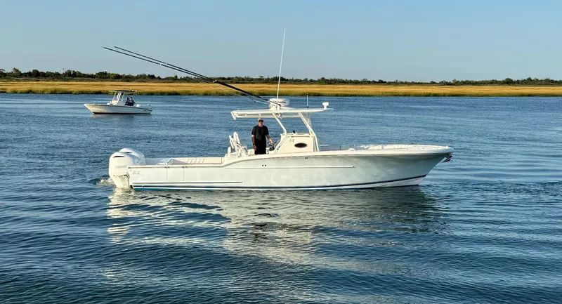 Slide: The Image of 2017 Buddy Davis 34 cc boat cruising on calm water. - 1