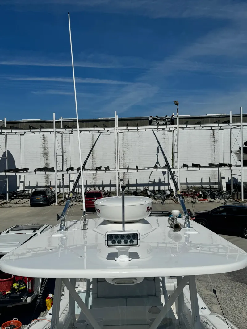 Slide: The Image of 2017 Buddy Davis 34 cc boat with radar and antennas, docked in a marina. - 21