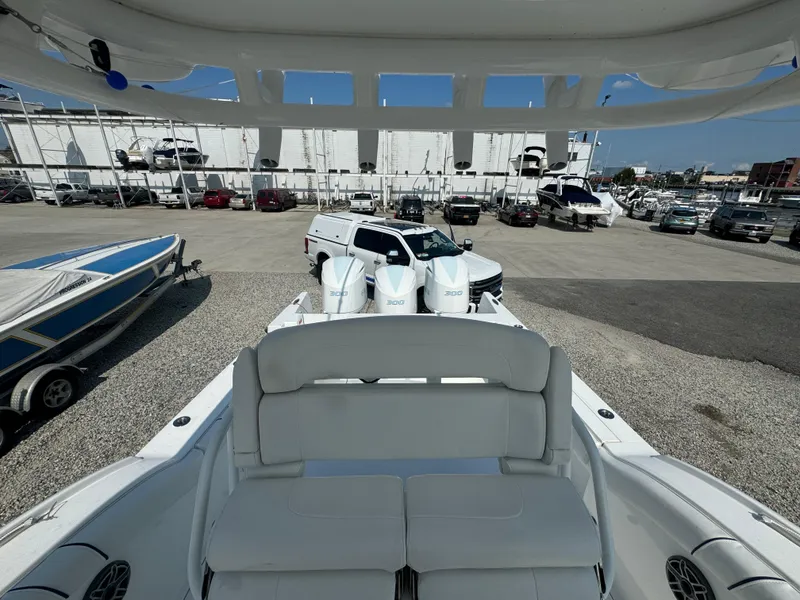 Slide: The Image of 2017 Buddy Davis 34 cc boat with triple 300 engines in a marina. - 24