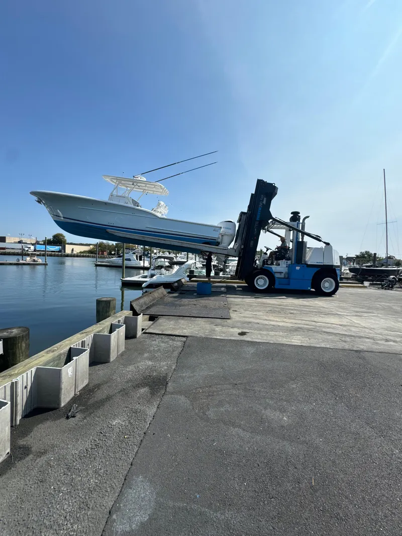 Slide: The Image of 2017 Buddy Davis 34 cc boat lifted by forklift at marina dock. - 28