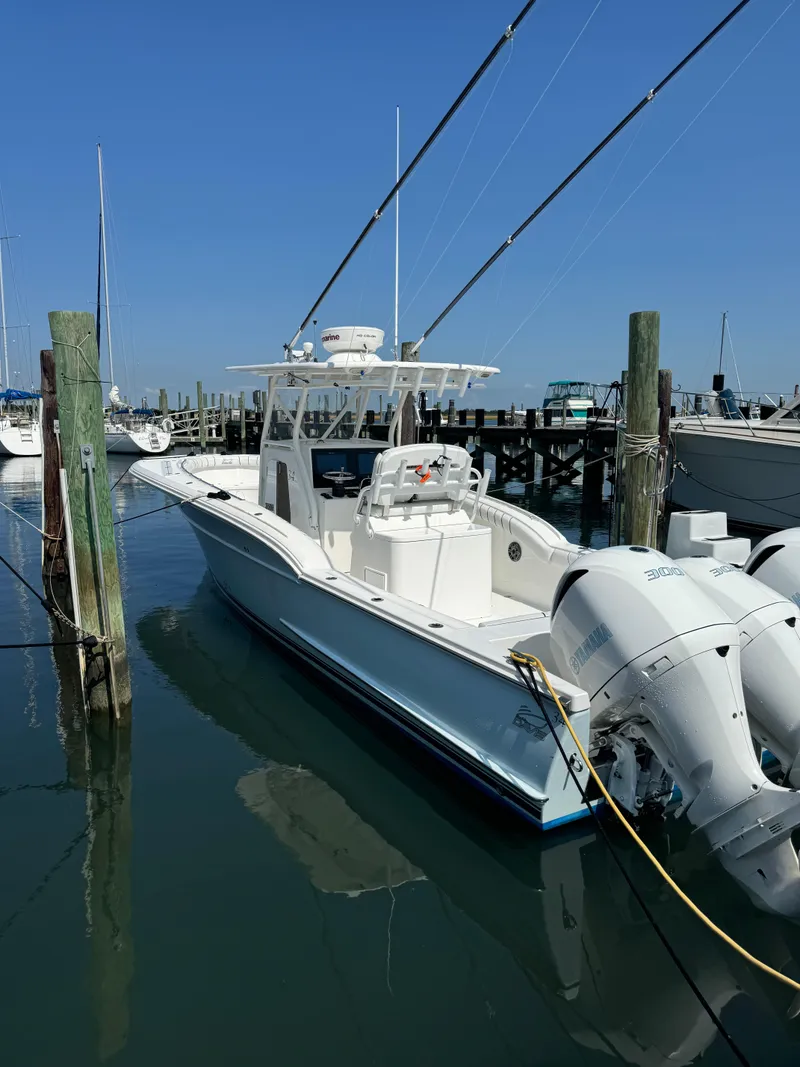 Slide: The Image of 2017 Buddy Davis 34 cc boat docked at marina with twin engines. - 3