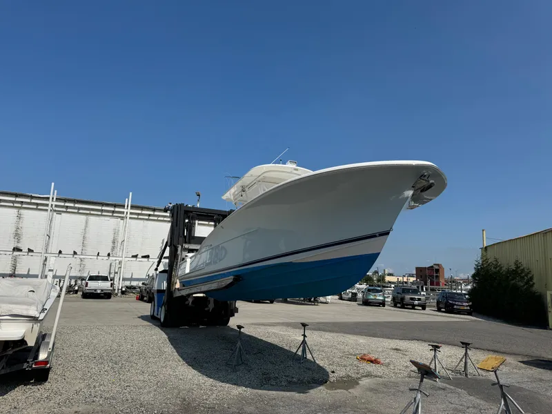 Slide: The Image of 2017 Buddy Davis 34 cc boat on a lift in a marina setting. - 5
