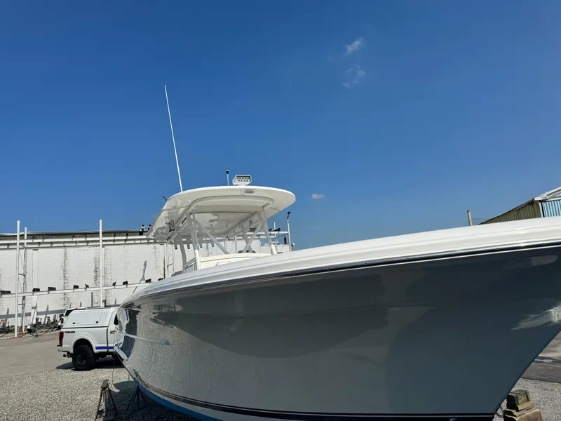 Slide: The Image of 2017 Buddy Davis 34 CC boat in a marina under clear blue sky. - 6