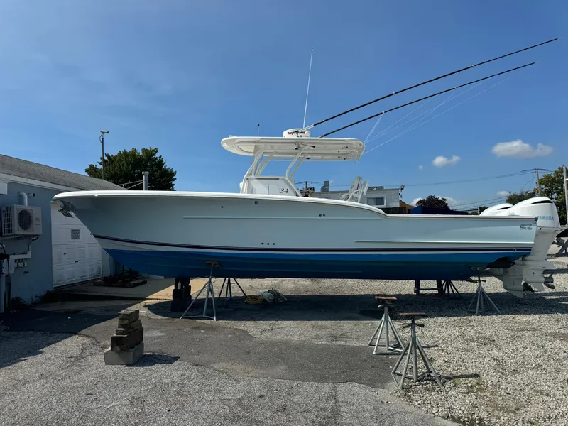 Slide: The Image of 2017 Buddy Davis 34 CC boat on stands, clear sky background. - 7
