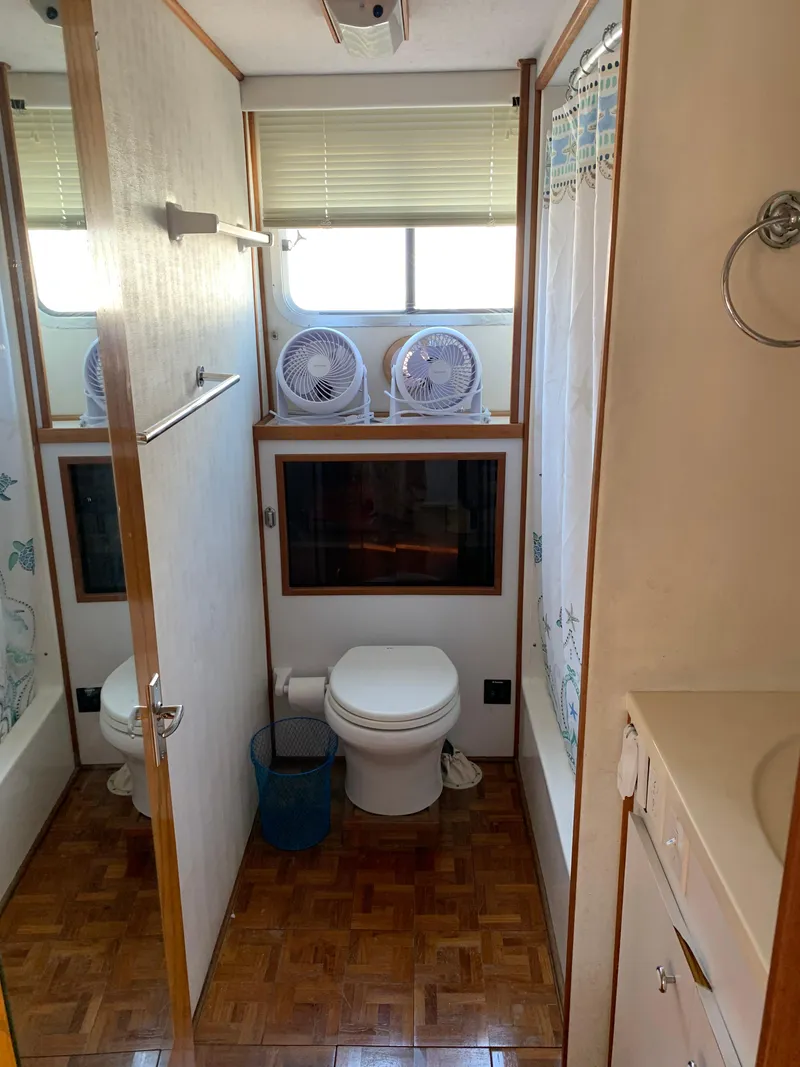 Slide: The Image of Bathroom interior of 1996 Harbor Master 460 WIDEBODY boat, featuring toilet and shower. - 10