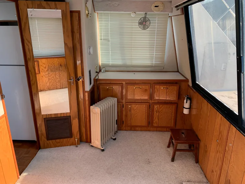 Slide: The Image of Interior of 1996 Harbor Master 460 WIDEBODY yacht with wood cabinetry and large window. - 13