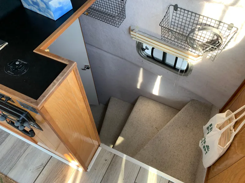 Slide: The Image of Interior stairs of 1996 Harbor Master 460 WIDEBODY yacht with carpet and storage baskets. - 14
