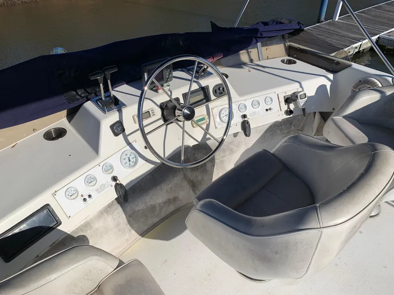 Slide: The Image of 1996 Harbor Master 460 WIDEBODY helm with steering wheel and control panel. - 18