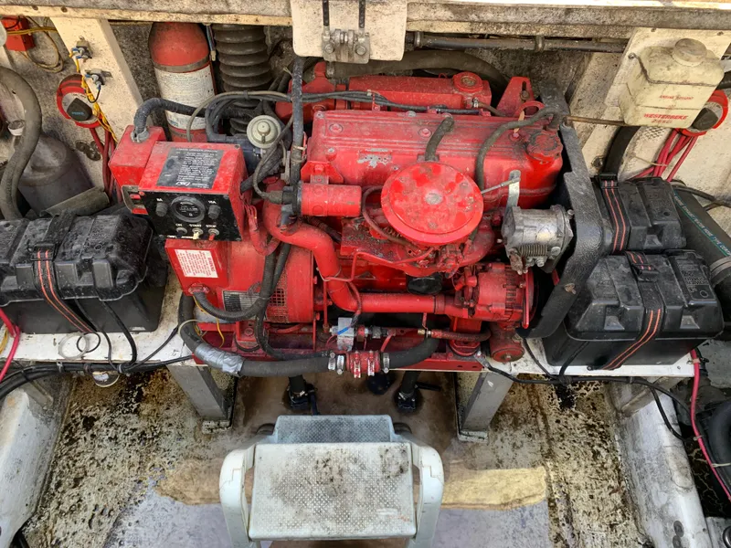 Slide: The Image of Engine compartment of a 1996 Harbor Master 460 WIDEBODY boat, featuring a red engine. - 23