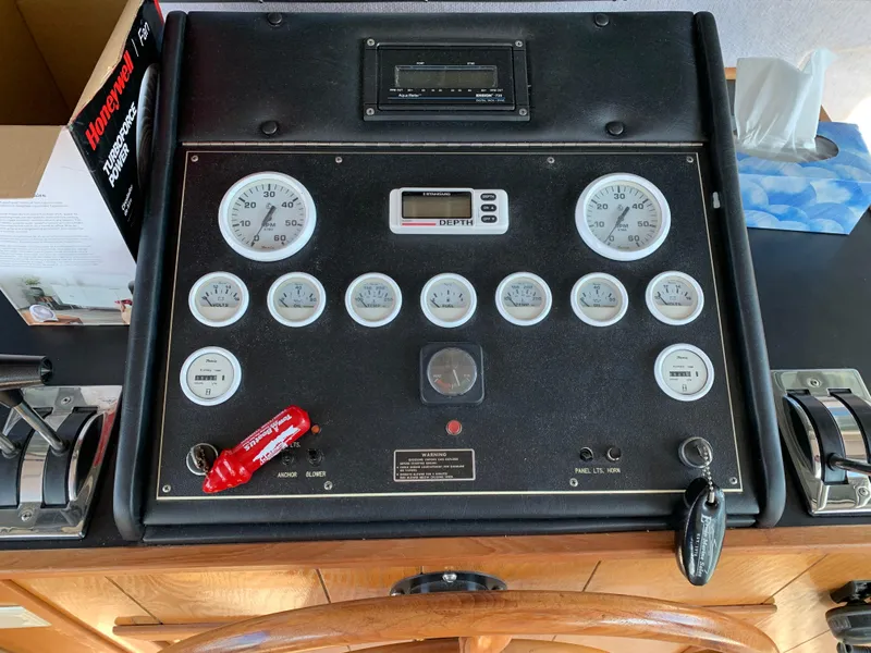 Slide: The Image of Control panel of a 1996 Harbor Master 460 WIDEBODY boat with gauges and switches. - 3