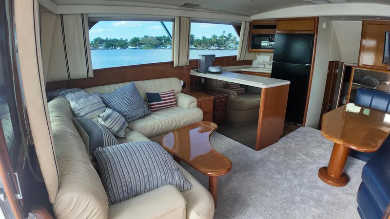 Slide: The Image of Luxurious interior of a 1999 Viking 47 Convertible yacht with plush seating and scenic views. - 10