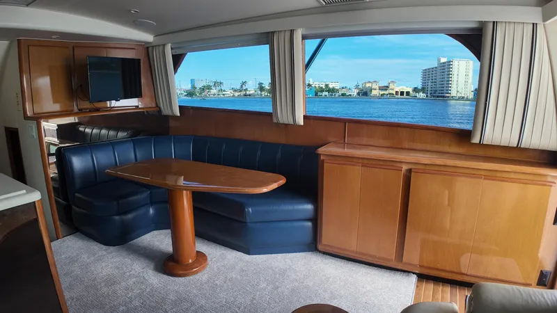 Slide: The Image of Interior of 1999 Viking 47 Convertible yacht with blue seating and waterfront view. - 12