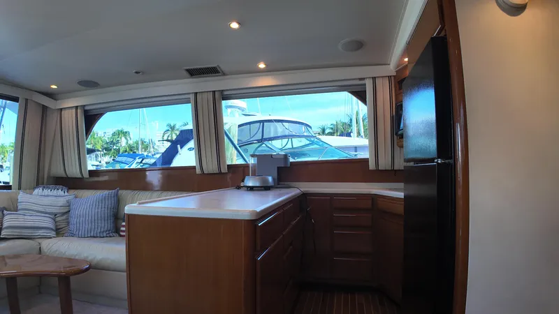 Slide: The Image of Interior of 1999 Viking 47 Convertible yacht with kitchen and seating area. - 14