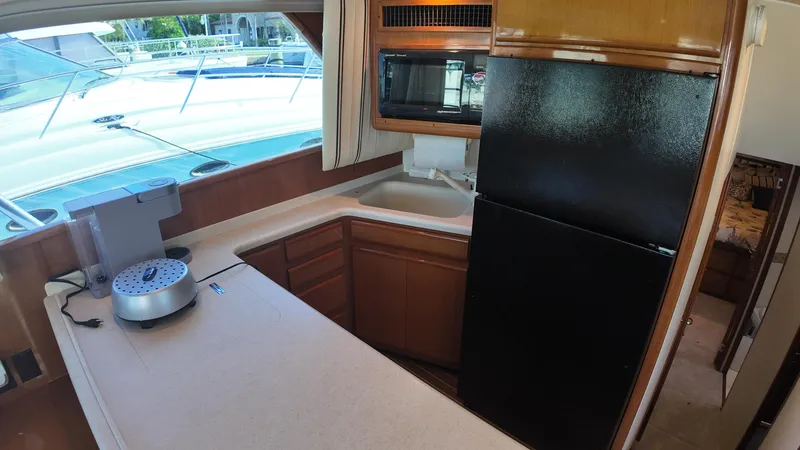 Slide: The Image of 1999 Viking 47 Convertible yacht kitchen with modern appliances and spacious countertops. - 15