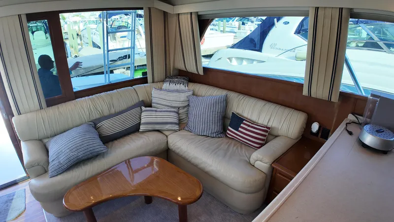 Slide: The Image of Cozy interior of 1999 Viking 47 Convertible yacht with plush seating and decorative pillows. - 17