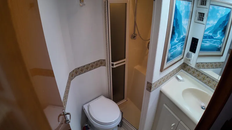 Slide: The Image of 1999 Viking 47 Convertible yacht bathroom with shower, toilet, and sink. - 20