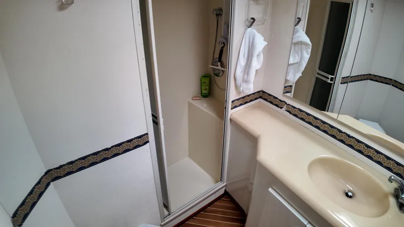 Slide: The Image of Bathroom interior of 1999 Viking 47 Convertible yacht with shower and sink. - 26