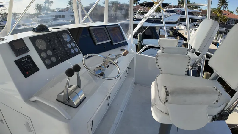Slide: The Image of 1999 Viking 47 Convertible yacht helm with controls and seating. - 29