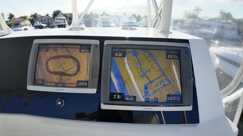 Slide: The Image of Navigation screens on a 1999 Viking 47 Convertible boat, displaying nautical maps. - 32