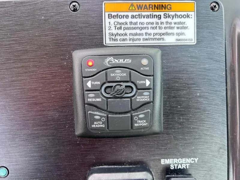 Slide: The Image of Control panel of a 2015 Sea Ray 330 Sundancer with Skyhook system and safety warning. - 15