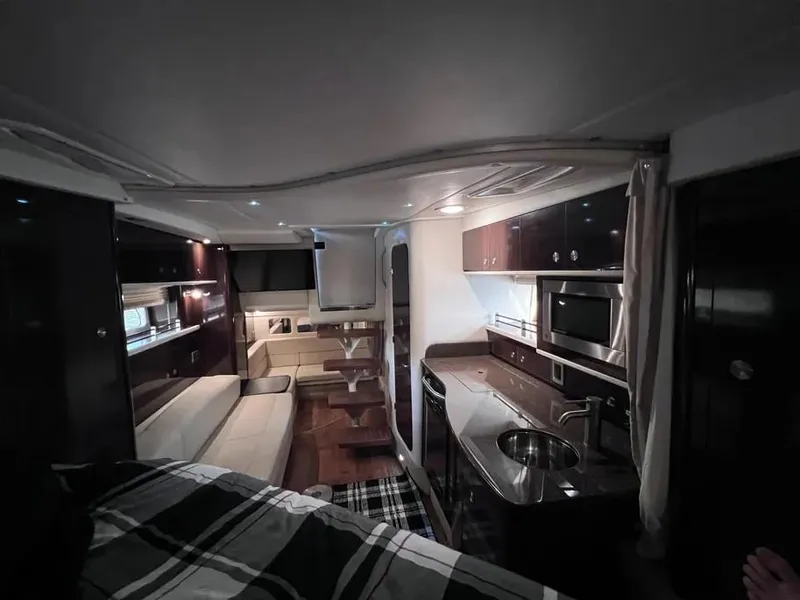 Slide: The Image of Interior of 2015 Sea Ray 330 Sundancer yacht with modern kitchen and seating area. - 21