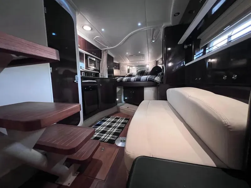 Slide: The Image of Interior of 2015 Sea Ray 330 Sundancer yacht with modern kitchen and cozy seating area. - 22