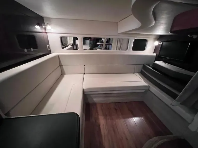 Slide: The Image of Interior of 2015 Sea Ray 330 Sundancer with modern seating and wood flooring. - 23