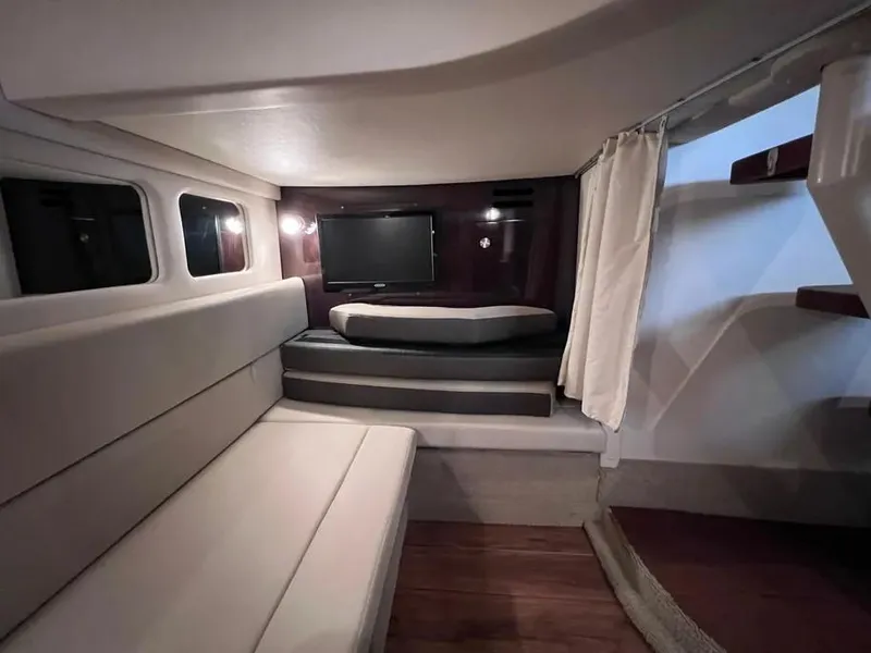 Slide: The Image of Interior of 2015 Sea Ray 330 Sundancer yacht with seating and TV. - 24