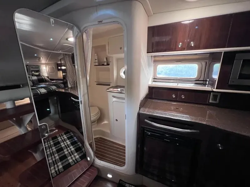 Slide: The Image of Interior of 2015 Sea Ray 330 Sundancer yacht with kitchenette and bathroom. - 25