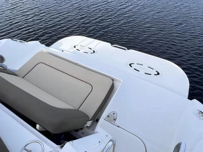 Slide: The Image of 2015 Sea Ray 330 Sundancer boat deck with seating, overlooking calm water. - 4