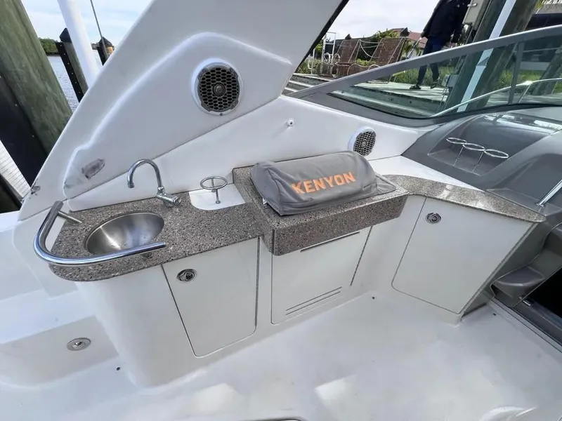 Slide: The Image of 2015 Sea Ray 330 Sundancer boat kitchenette with sink and Kenyon grill. - 8