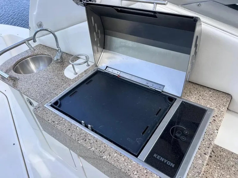 Slide: The Image of Outdoor kitchen on 2015 Sea Ray 330 Sundancer yacht with Kenyon grill and sink. - 9