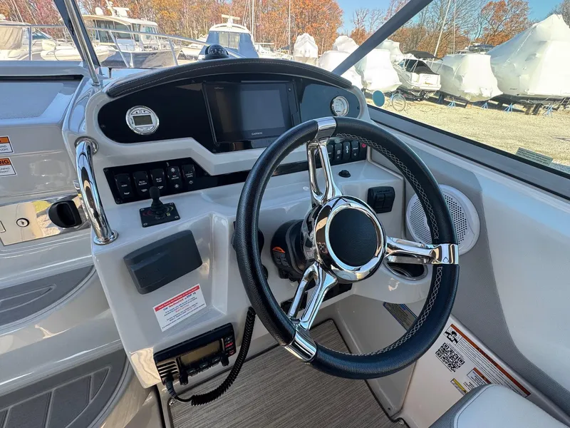 Slide: The Image of 2019 Regal 26 XO boat dashboard with steering wheel and control panel. - 1