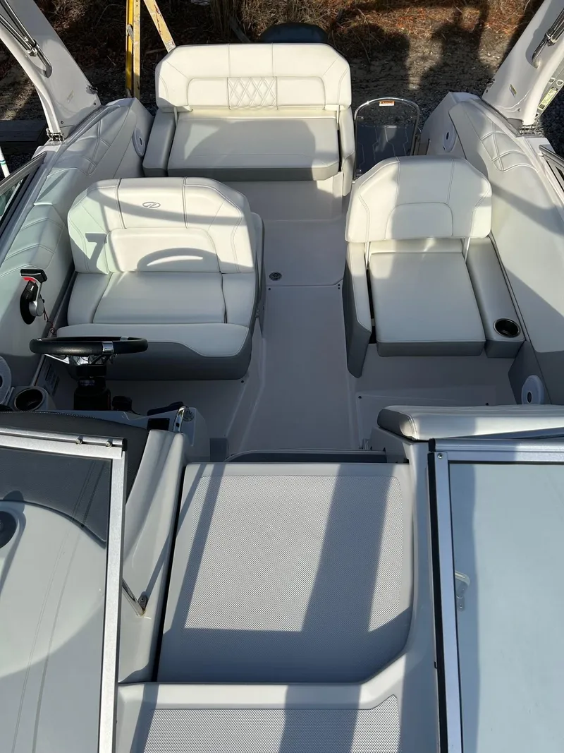 Slide: The Image of 2019 Regal 26 XO boat interior with white seating and modern design. - 16