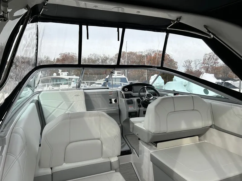Slide: The Image of Interior of 2019 Regal 26 XO boat with white seating and modern dashboard. - 2