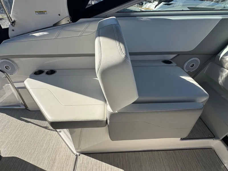 Slide: The Image of 2019 Regal 26 XO boat interior with adjustable seating and cup holders. - 21