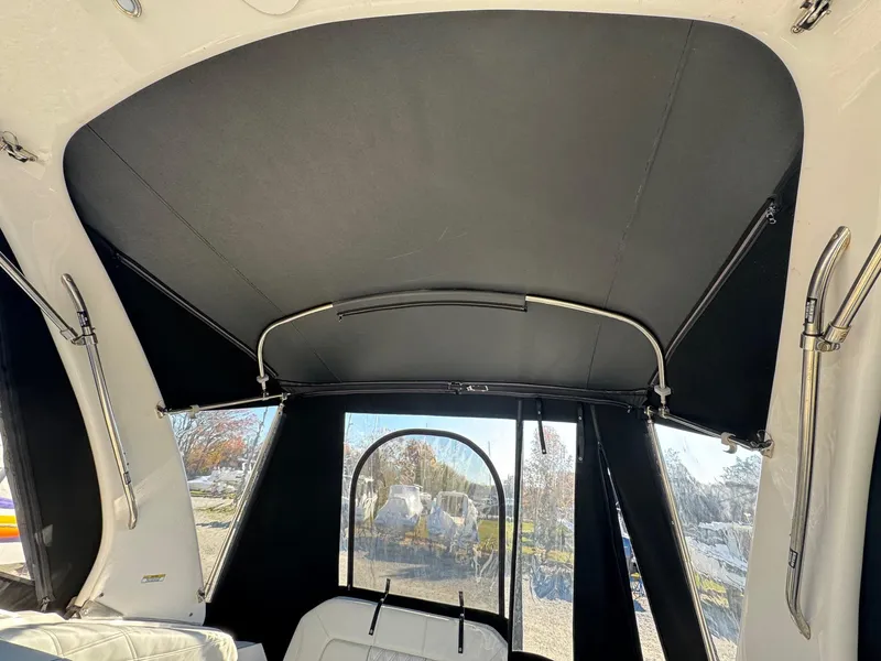 Slide: The Image of 2019 Regal 26 XO boat interior with black canopy and seating. - 25