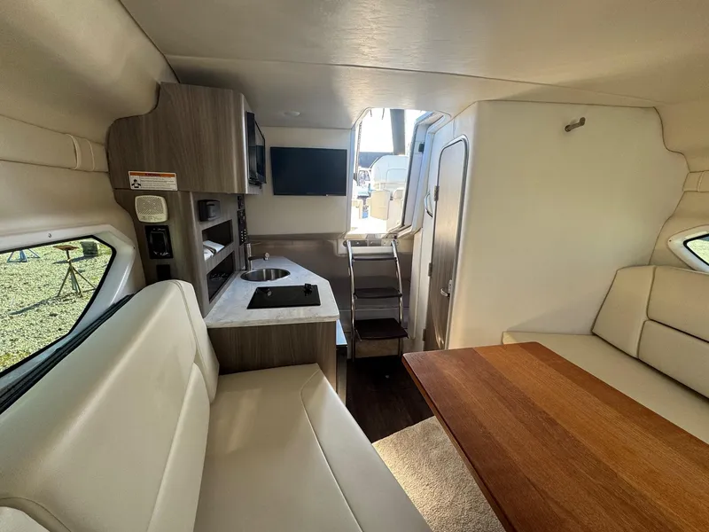 Slide: The Image of Interior of 2019 Regal 26 XO boat with kitchenette and seating area. - 28