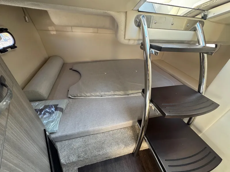 Slide: The Image of 2019 Regal 26 XO cabin interior with compact sleeping area and modern ladder. - 29