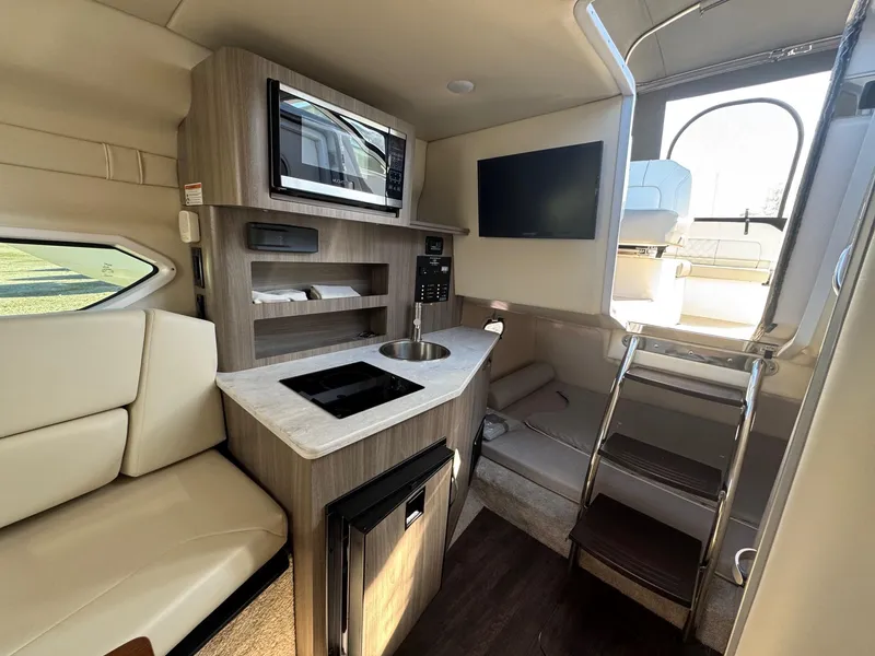 Slide: The Image of 2019 Regal 26 XO boat interior with kitchenette, seating, and modern amenities. - 3