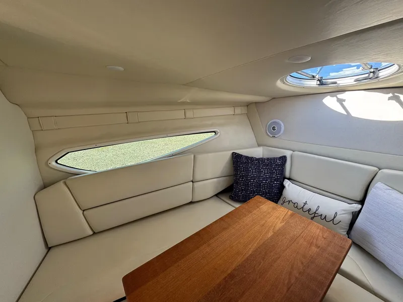 Slide: The Image of 2019 Regal 26 XO cabin interior with cozy seating and wooden table. - 33