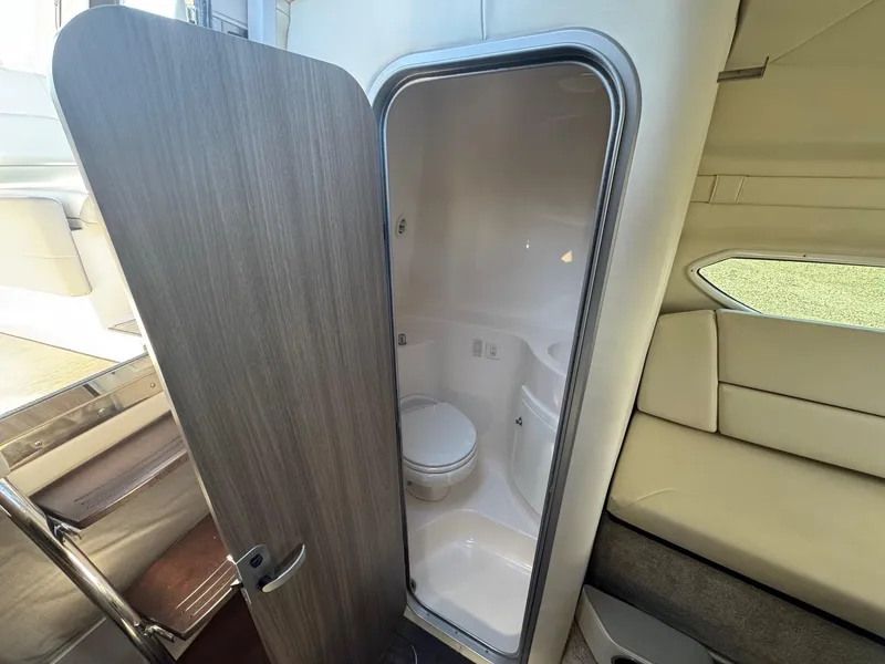 Slide: The Image of 2019 Regal 26 XO boat interior with compact bathroom and seating area. - 35