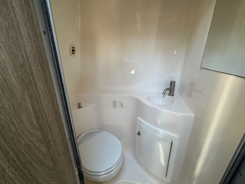 Slide: The Image of 2019 Regal 26 XO boat bathroom with compact toilet and sink. - 36