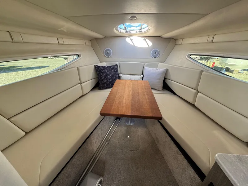 Slide: The Image of Luxurious interior of 2019 Regal 26 XO boat with plush seating and wooden table. - 4