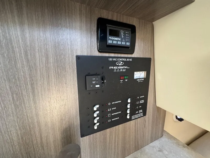 Slide: The Image of Control panel of 2019 Regal 26 XO boat, featuring switches and digital display. - 41