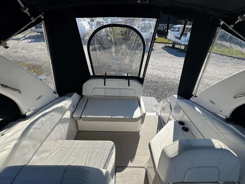 Slide: The Image of 2019 Regal 26 XO boat interior with white seating and canopy. - 6